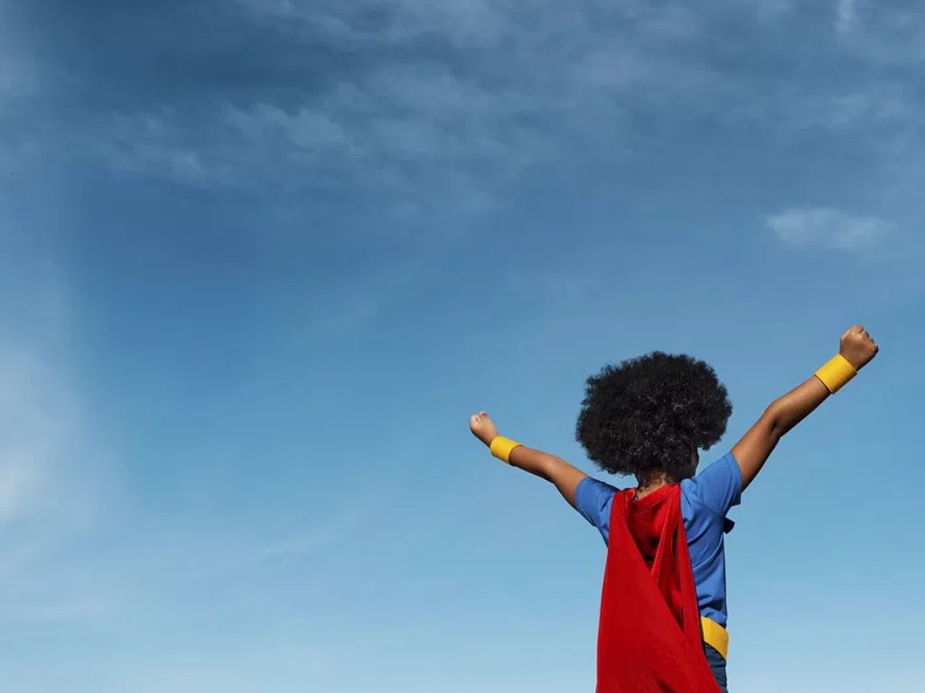 Girl with afro playing superhero