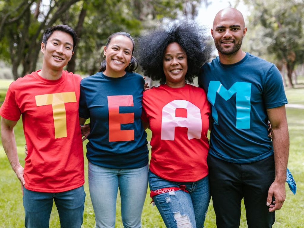 Group of people wearing shirts spelled team