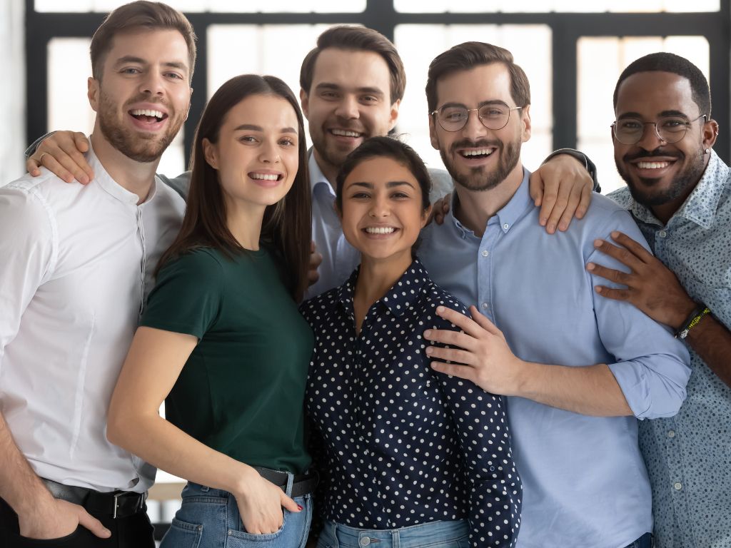 Group portrait of smiling diverse multiracial young businesspeople posing together in office