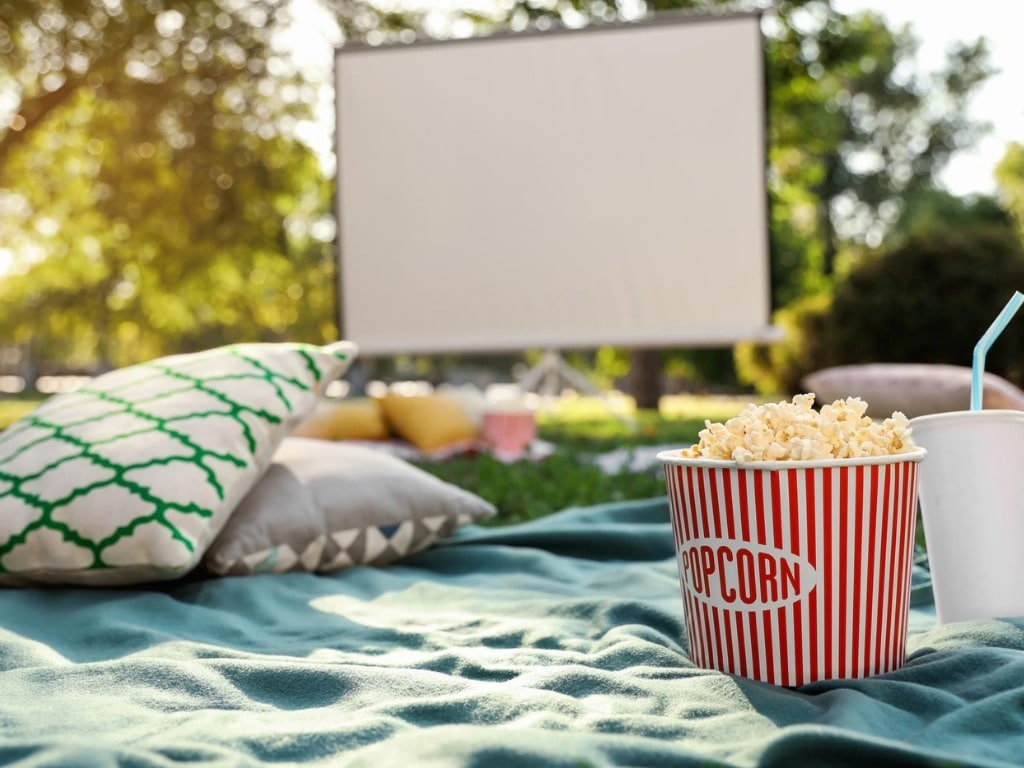 Popcorn & drinks at a Christmas movie picnic in Sydney parklands.